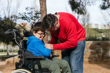father-playing-with-his-son-with-disability-in-a-w