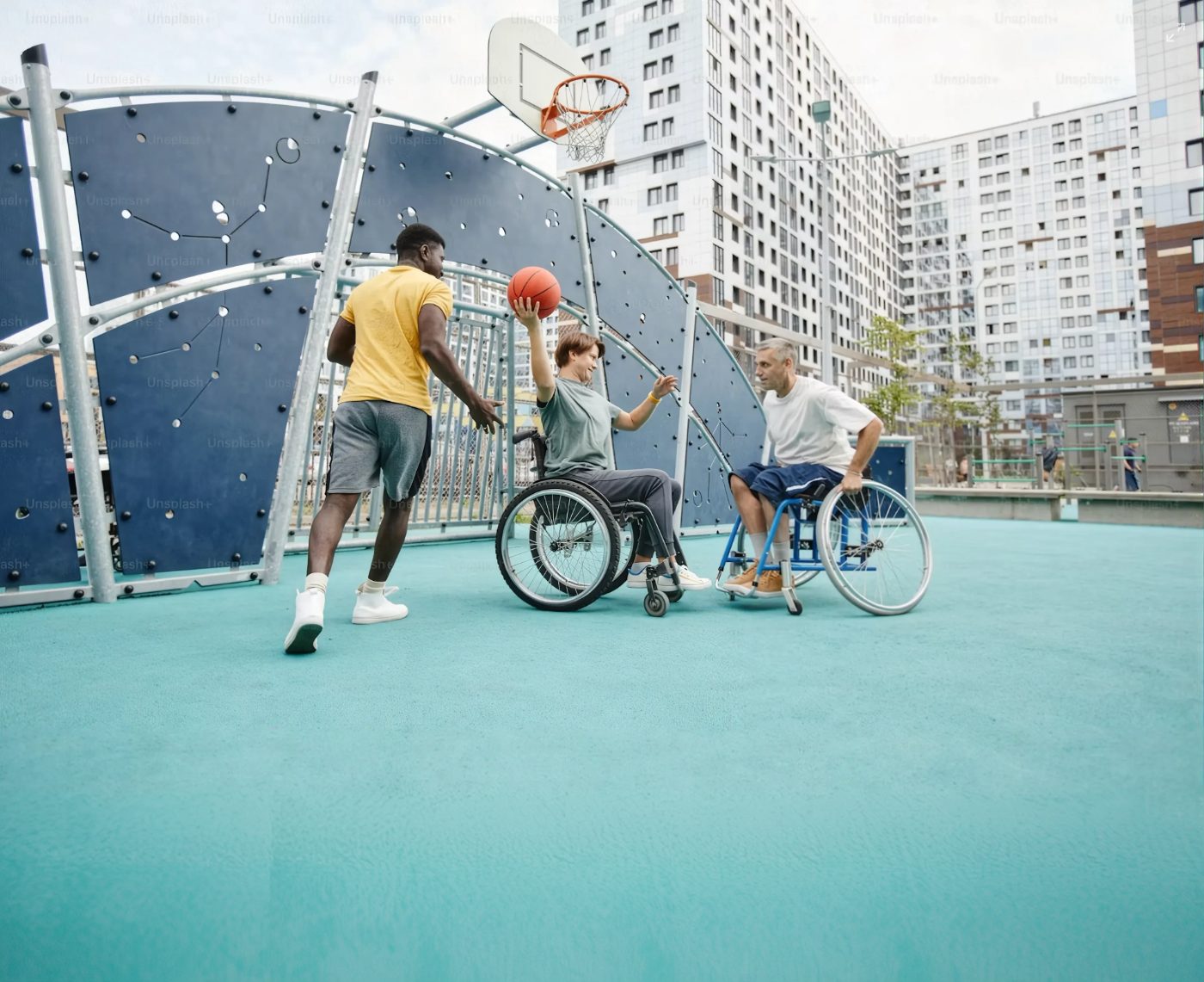 Young people in wheelchairs playing basketball together